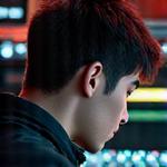 Portrait of Samuel Chen, Lead Music Producer, focused and intense in a studio setting.